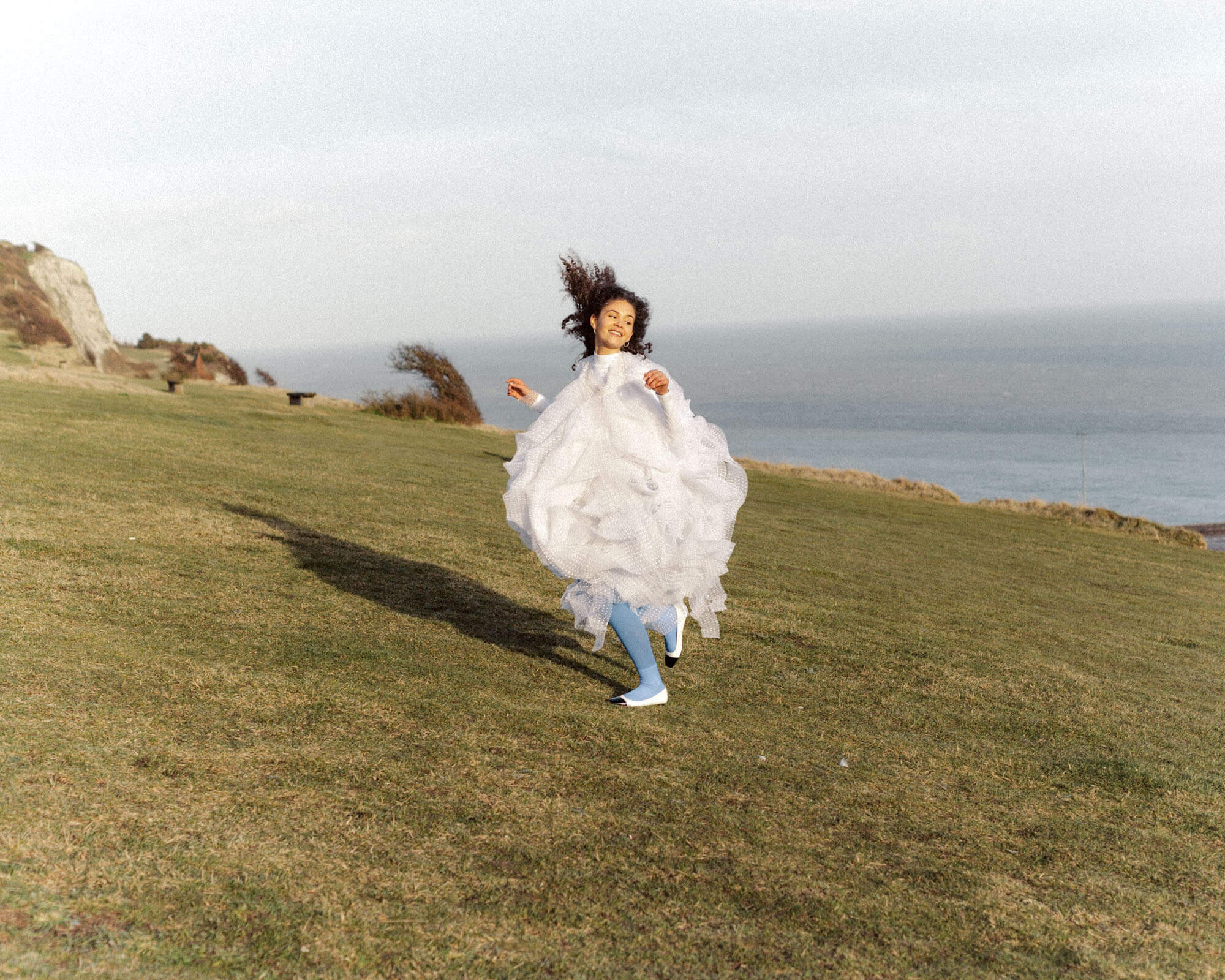 A joyful Ilana in an editorial at the White Cliffs of Dover, England