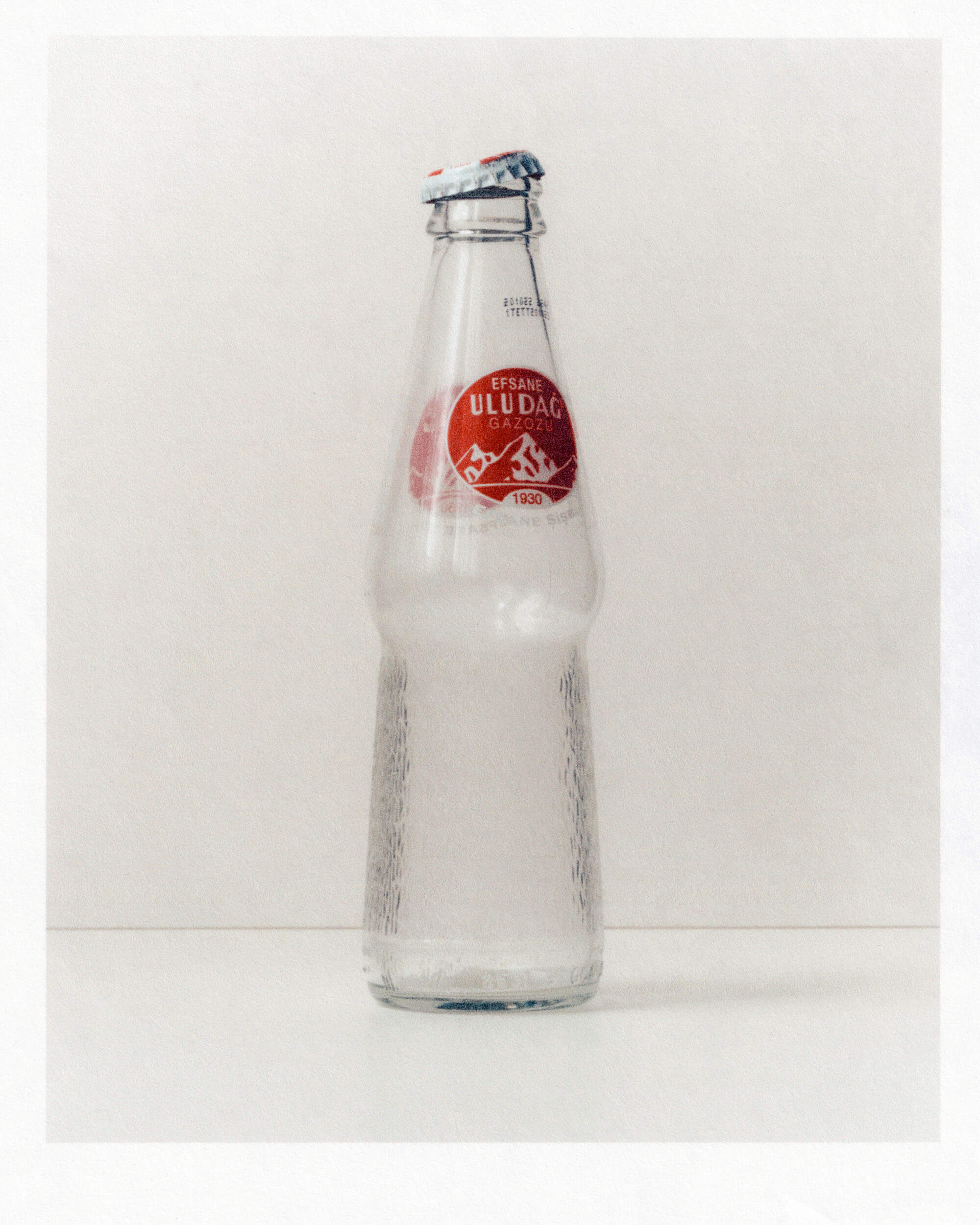 Print of a still life of an empty bottle of Uludag